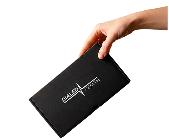 Hand holding a Dialed Health treatment box